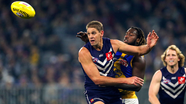 Aaron Sandilands battles long-time ally Nic Naitanui in this year's derby ... the 211cm giant announced his retirement on Tuesday.