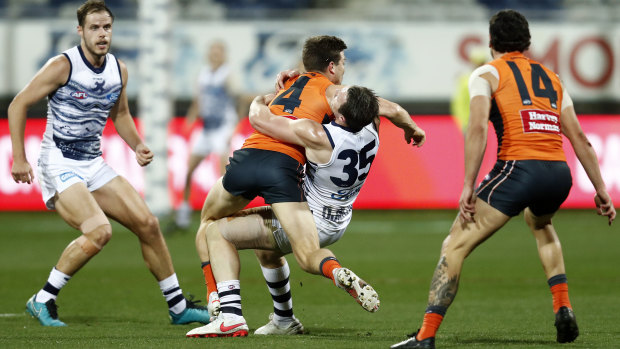 Toby Greene catches Patrick Dangerfield high as he tries to fend off a tackle.