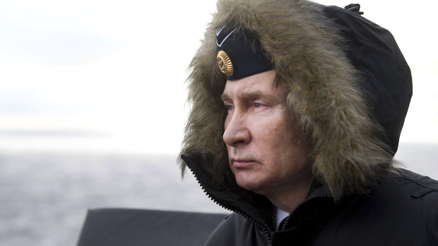Russian President Vladimir Putin watches a navy exercise from the Marshal Ustinov missile cruiser in the Black Sea, Crimea, in January.