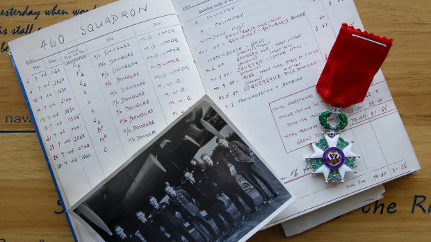 Ken Willis, second from right, is seen in a photo of 460 Squadron, along with a log book showing the missions he flew over France, and the Legion of Honour medal he was awarded in 2018. 