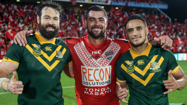 Mate against mate: Fifita poses with Kangaroos Aaron Woods and Valentine Holmes after the match.