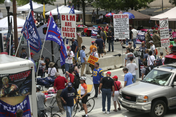 People gather as they make their way toward BOK Centre in downtown Tulsa ahead of President Donald Trump's rally.