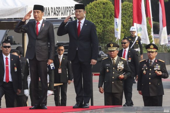 Former Indonesian social affairs minister Juliari Batubara, right, with President Joko Widodo. Juliari was jailed for corruption last month.