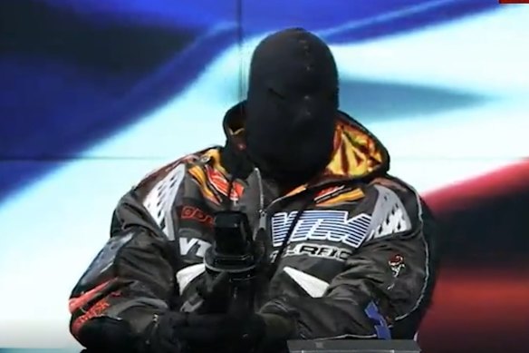 Kanye West, now known as Ye, appears masked and behind a copy of the Bible, on Infowars on December 1. He also wore a balaclava to the BET Awards in Los Angeles in June.