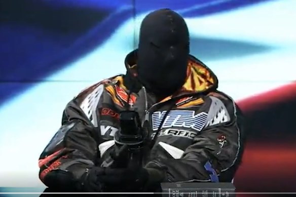Kanye West, now known as Ye, appears masked and behind a copy of the Bible, on Infowars on December 1. He also wore a balaclava to the BET Awards in Los Angeles in June.