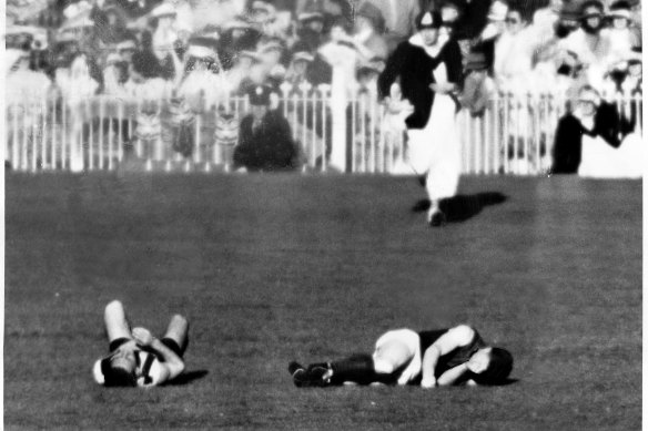 Frank Adams (right) collides with Collingwood's Des Healey in the 1955 grand final.