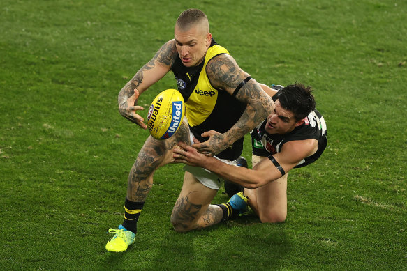 Richmond's Dustin Martin is challenged by Brayden Maynard of the Magpies.