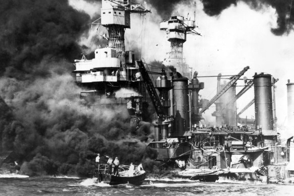 An American sailor is rescued from the sunken and burning battleship USS West Virginia during the Japanese attack on Pearl Harbour on December 7, 1941. 