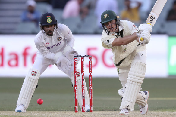 Marnus Labuschagne plays a shot in front of India's Wriddhiman Saha. 