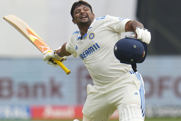 Sarfaraz Khan celebrates his debut Test hundred against New Zealand.