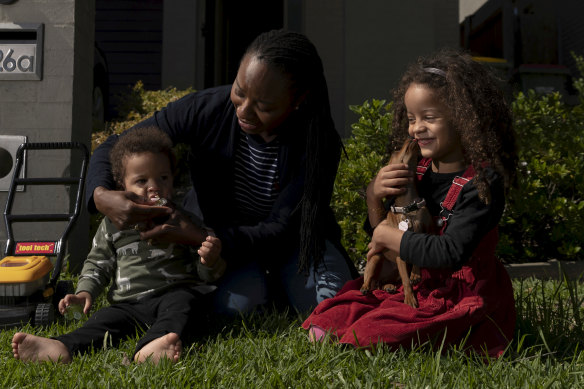 Dr Tinashe Moira Dune, an academic at Western Sydney University, with her children, Naya and Yarran.