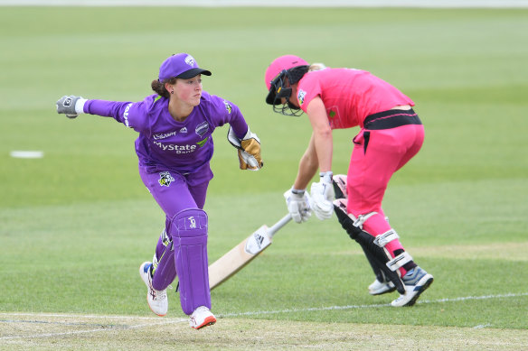 Emily Smith, left, in action for Hobart. Her suspension has divided the cricket community. 