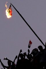 Iraqi Anti-government protesters burn the Iranian flag during a demonstration in Baghdad, Iraq.