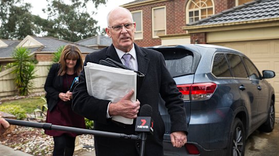 IBAC investigators outside Adem Somyurek's home on Tuesday. 