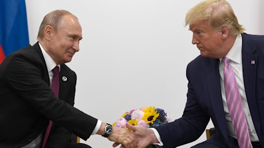 Russian President Vladimir Putin shakes hands with US President Donald Trump in 2019.