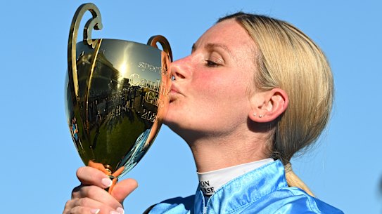 Sealed with a kiss: Jamie Melham is the first woman jockey to win the Caulfield Cup.