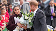Meghan, Duchess of Sussex holds a bouquet of flowers as she and Prince Harry, Duke of Sussex arrive at the Community Recording Studio (CRS),