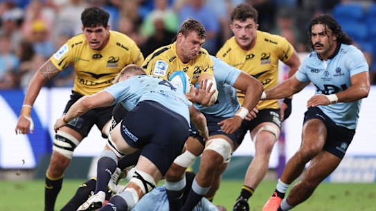 Nicholas Champion de Crespigny of the Force is tackled by the Waratahs.