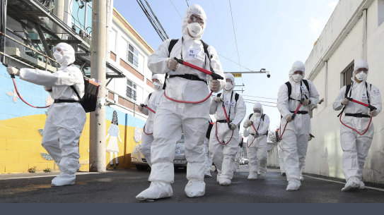 Soldiers spray disinfectant as a precaution against the coronavirus in Gyeongsan, South Korea.