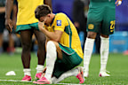 Socceroos players react to their World Cup elimination.
