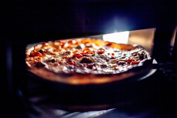The pizza is cooked in electric ovens. 