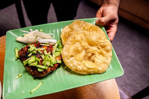 Chicken chop with fried flatbread luchi.
