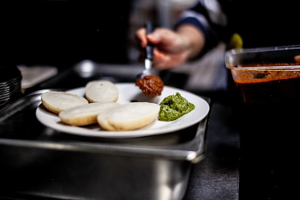 Chitoi pitha served with two savoury condiments known as vorta.