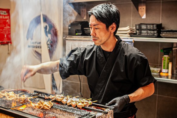 Chef Naoyuki Suzuki on the grill in the Yakitori Washokudo kitchen.