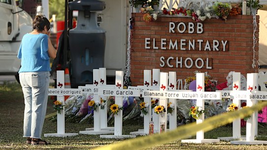 Dora Mendoza, grandmother of shooting victim Amerie Jo Garza, wipes tears from her eyes at a memorial site at Robb Elementary School.
