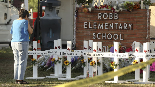 Dora Mendoza, grandmother of shooting victim Amerie Jo Garza, wipes tears from her eyes at a memorial site at Robb Elementary School.

