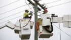 Workers installing NBN fibre optic cable.