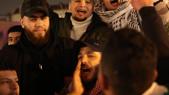 Young Arab men celebrate the announcement of the Gaza ceasefire. 