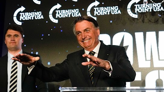 Brazil’s right wing former President Jair Bolsonaro, right, speaks alongside Turning Point USA founder Charlie Kirk, at a TPUSA event at Trump National Doral, Miami.