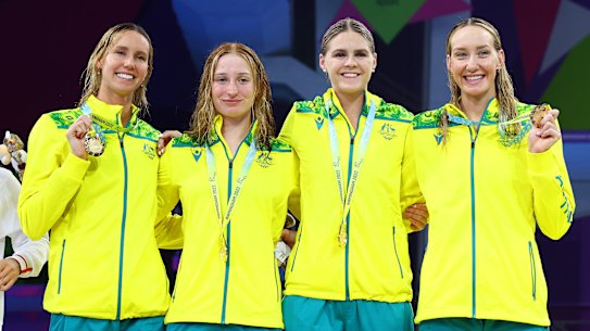 Emma McKeon (left) poses with her 10th Commonwealth Games gold medal alongside her relay teammates Mollie O’Callaghan, Shayna Jack and Madi Wilson.