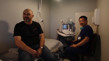 Mark Tunks, 55, after he had the iTIND device removed. Mr Tunks is pictured with Professor Henry Woo. 