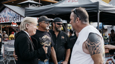 Attendees pose with a person in a Donald Trump mask, at a biker rally in South Dakota last week.