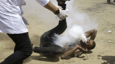 A Palestinian medic rushes to help a protester who was shot in the face with a teargas canister fired by Israeli troops near the Gaza Strip's border with Israel last Friday.