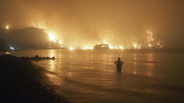 Wildfires approaching a Greek island beach last summer.