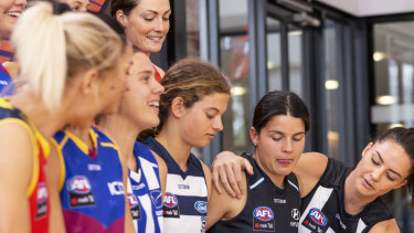 AFLW players attend a launch last year of a four-year broadcast deal with Foxtel and Seven.