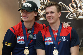 James Jordon (right) and his Melbourne teammate Trent Rivers with their premiership medallions.
