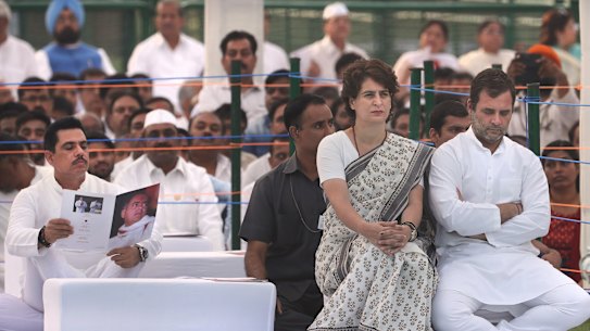 Congress Party President Rahul Gandhi, right, with his sister and party general secretary Priyanka Gandhi Vadra, second right, sit as her husband Robert Vadra, left, reads a booklet on Rajiv Gandhi during a function to pay homage to former Indian prime minister on his death anniversary on Tuesday.