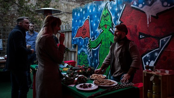 Alex Malenki, right, and his wife, Ingrid Weiss, at a Christmas market hosted by Generation Identity, a far-right youth movement, in Halle, Germany.