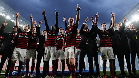 Mitchell Duke of the Wanderers leads his teammates in celebrations at Bankwest Stadium.