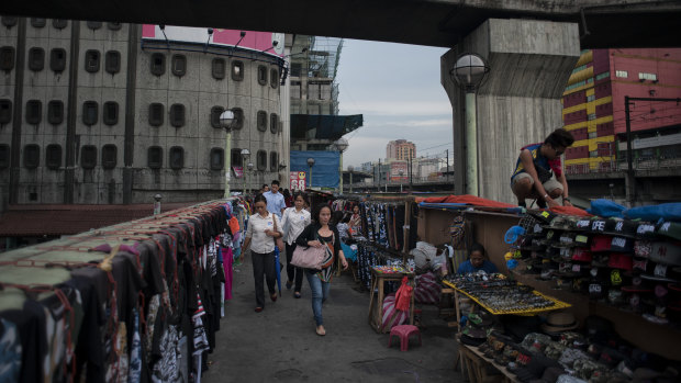 Street hawkers on an overpass above Epifanio de los Santos Avenue in Manila. The decades of democracy have not alleviated the plight of the poor.