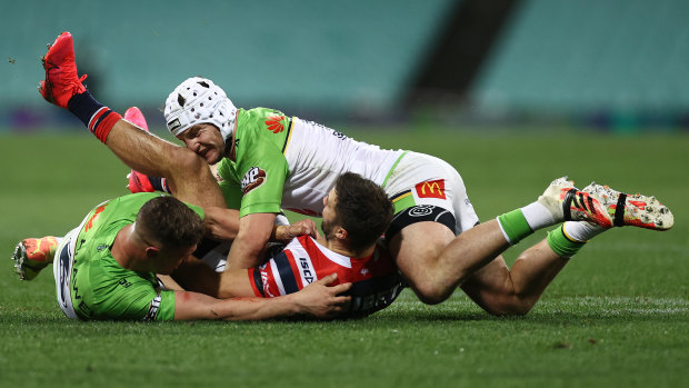 James Tedesco is smothered by the Raiders defence.