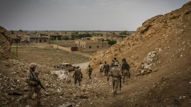 Iraqi border guard troops patrol the Syrian border near Qaim, in April.
