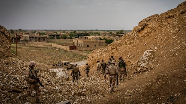 Iraqi border guard troops patrol the Syrian border near Qaim, in April.