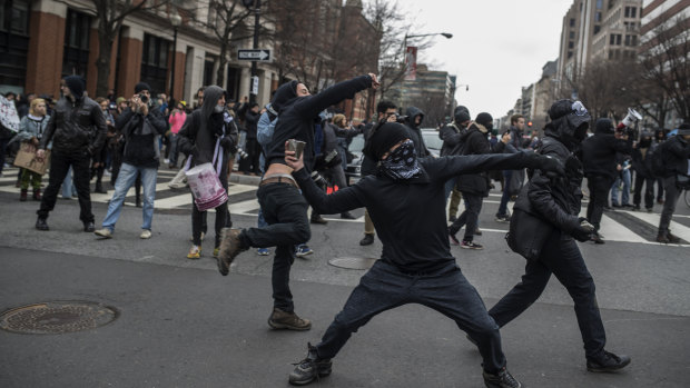 Rioters in Washington, DC, throw rocks during a protest on January 20, 2017 - inauguration day.