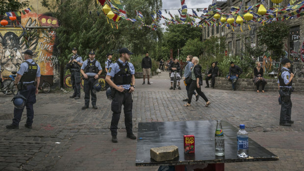 Police officers search for hashish and marijuana at Pusher Street in Christiania Freetown, the hippie commune in the centre of Copenhagen, Denmark.