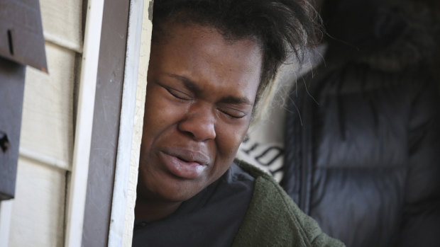 Sandra Parks' sister Tatiana Ingram weeps after Sandra was killed by a stray bullet. 